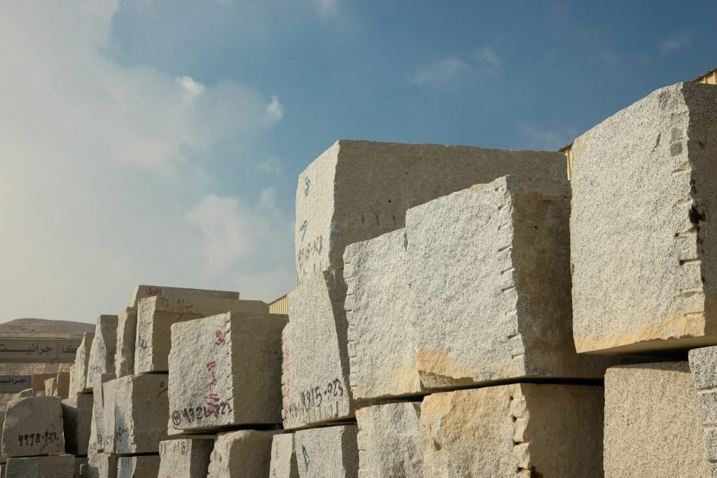 Granite blocks stacked in the yard at Alexandria, each painted with its own block number